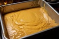 banana bread dough poured into a greased pan