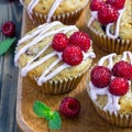 Banana bread muffins with raspberries, cherries and white chocolate on wooden board, square format Royalty Free Stock Photo