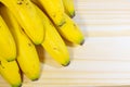 Banana bunch isolated on wooden table, top view Royalty Free Stock Photo