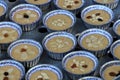 Banana cakes are packed in paper cups, placed in a large aluminum steamer and steamed.
