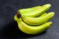 Banana called guineo or bocadillo Musa acuminata. Black background. Top view. Space for text. Tropical fruit