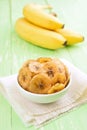 Banana chips in bowl and fresh bananas Royalty Free Stock Photo