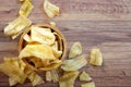 Banana chips in wooden bowl on wooden background Royalty Free Stock Photo