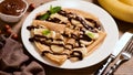 Banana Chocolate Crepes Served On White Plate