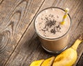 Banana chocolate smoothie glass on wooden table Royalty Free Stock Photo