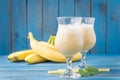 Banana daiquiri in glass and bananas Royalty Free Stock Photo