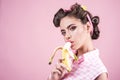 Banana dieting. pin up woman with trendy makeup. pinup girl with fashion hair. retro woman eating banana. pretty girl in