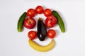 Banana, eggplant, tomatoes, apples and cucumbers are located in the form of a face.