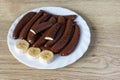 Banana flavored slices covered in chocolate on a plate Royalty Free Stock Photo