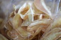 Banana fried pieces slice thin in plastic clear bag, Banana fried snack, Banana fried pieces close up selective focus