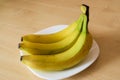 Banana fruits on the plate on the table.