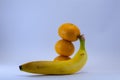 Banana and group of tangerines, mandarins isolated over white Royalty Free Stock Photo