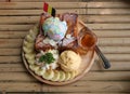 Banana honey toast with ice cream in the wooden plate on the bamboo table. Royalty Free Stock Photo