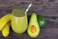 Banana Juice and avocado smoothies and green juice drink healthy, delicious taste in a glass for weight loss on wooden background. Royalty Free Stock Photo