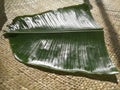 Banana leaf for Onam sadhya placed on a mat.
