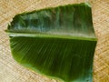 Banana leaf for Onam sadhya placed on a mat.
