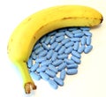Banana with many blue pills for male problems Royalty Free Stock Photo