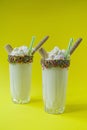 Banana milkshake with ice cream and whipped cream, marshmallows, cookies, waffles, served in a glass cup Royalty Free Stock Photo