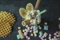 Banana milkshake with ice cream and whipped cream, marshmallows, cookies, waffles, served in a glass cup decorated with Royalty Free Stock Photo