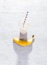 Banana milkshake in plastic cup on white Royalty Free Stock Photo