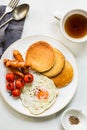 Banana Oat Pancakes with Fried egg,Sausages and Cherry Tomatoes Royalty Free Stock Photo