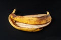 Banana peel on a black background. Heap of overripe banana close-up