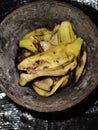 Banana peel in cigarette ashtray container, Indonesia April 27, 2024 Royalty Free Stock Photo