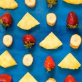 Banana, pineapple, strawberry pattern sliced on blue, top view