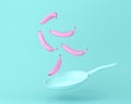 Banana pink floating with pan on pastel blue background. minimal concept fruits and food