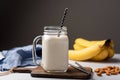 Banana protein smoothie or milkshake in drinking glass