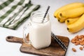 Banana protein smoothie or milkshake in drinking glass