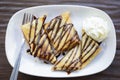 Banana samosas topped with chocolate whipped cream