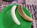 Banana skin on and skin off comparison Royalty Free Stock Photo