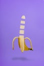 Banana Slice Isolated Flying on Purple Background Royalty Free Stock Photo