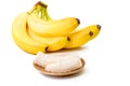 Banana slices on a brown plate and bunch of ripe bananas isolate Royalty Free Stock Photo