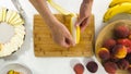 Banana Slices on a Chopping Board Close Up on White Background, Woman Hands. Fresh Fruit Platter Royalty Free Stock Photo