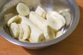 Banana slices close-up in a metal plate on a wooden table with copy space. Top view of tropical fruits and healthy eating Royalty Free Stock Photo