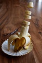 Banana slices lavitating above a wooden table. Banana levitation