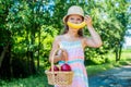 Banana smile. Girl in garden hold apple and basket harvested fruits