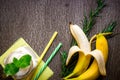 Banana smoothie and fresh banana on wooden table. Royalty Free Stock Photo