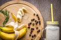 Banana smoothie and fresh banana on wooden table. Royalty Free Stock Photo