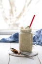 Banana smoothie with peanut butter, cinnamon and granola for healthy breakfast