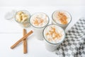 Banana smothie or milkshake with cinnamon on white background