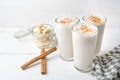 Banana smothie or milkshake with cinnamon on white background