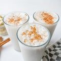 Banana smothie or milkshake with cinnamon on white background