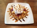 Banana split with whip cream, ice cream, strawberry jam and syrup on top of waffle Royalty Free Stock Photo