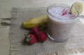 Banana Strawberry Milkshake. Glass cup on a wooden background. Homemade Royalty Free Stock Photo