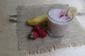 Banana Strawberry Milkshake. Glass cup on a wooden background. Homemade Royalty Free Stock Photo