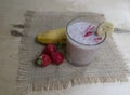 Banana Strawberry Milkshake. Glass cup on a wooden background. Homemade Royalty Free Stock Photo