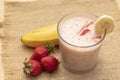 Banana Strawberry Milkshake. Glass cup on a wooden background. Homemade Royalty Free Stock Photo